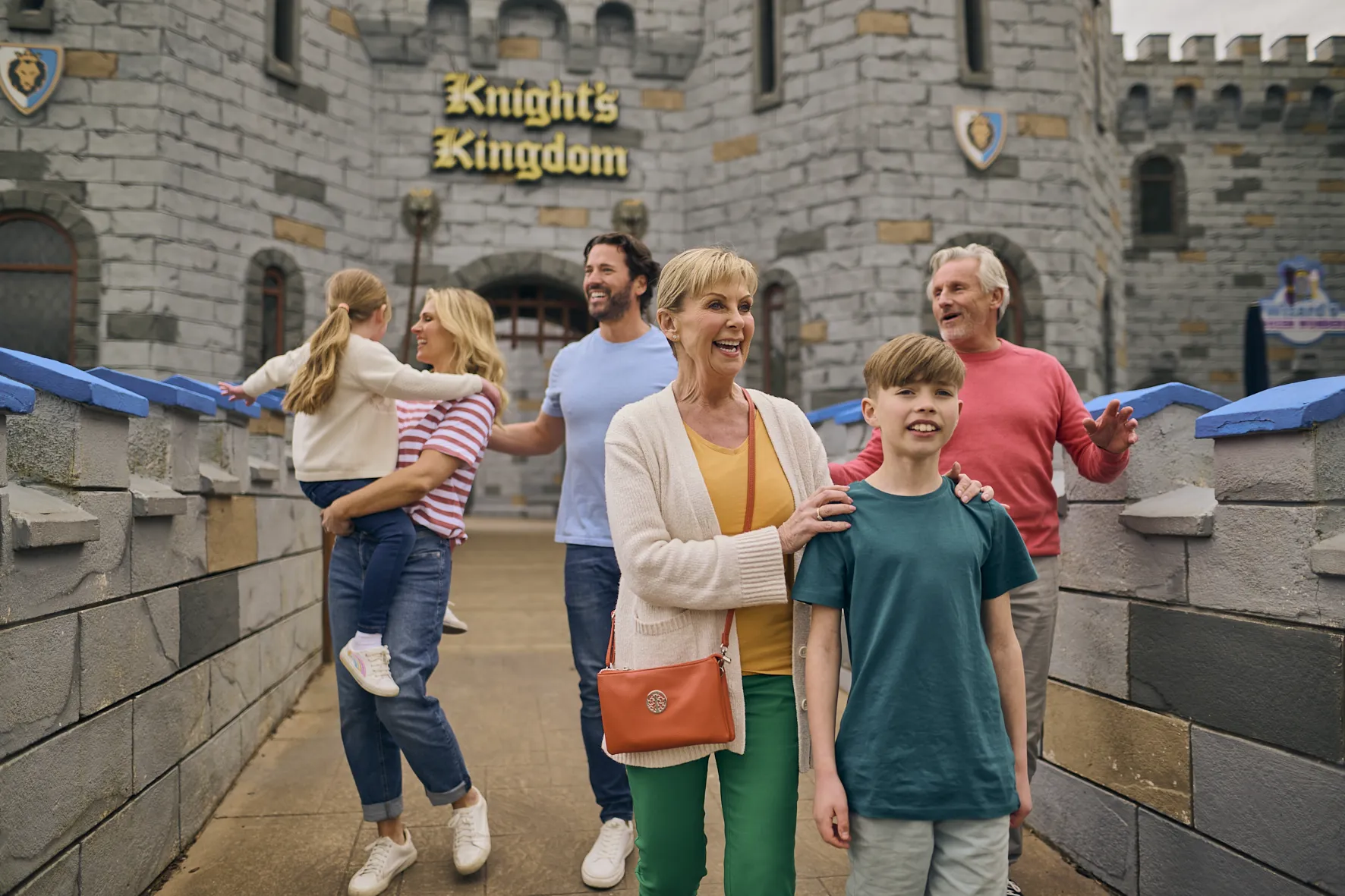 Parents, grandparens and 2 children on drawbridge of castle in Knight's Kingdom at LEGOLAND Windsor
