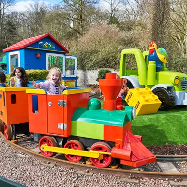 Girls smiling and waving on DUPLO Train