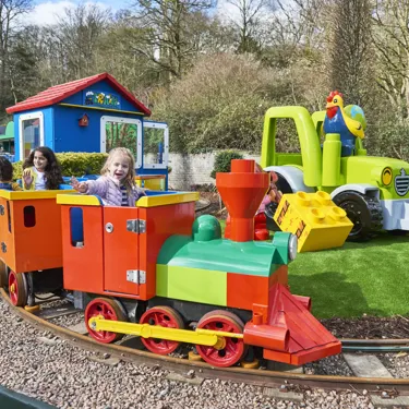 Girls smiling and waving on DUPLO Train