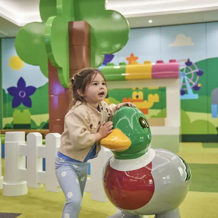 Girl with model of DUPLO duck in the LEGOLAND Playroom