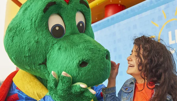 Girl laughing with Ollie the Dragon at the LEGOLAND Windsor Resort