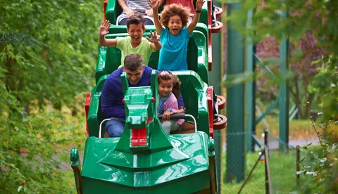 Family smiling on The Dragon at the LEGOLAND® Windsor Resort