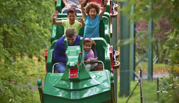 Family smiling on The Dragon at the LEGOLAND® Windsor Resort