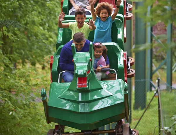 Family smiling on The Dragon at the LEGOLAND® Windsor Resort