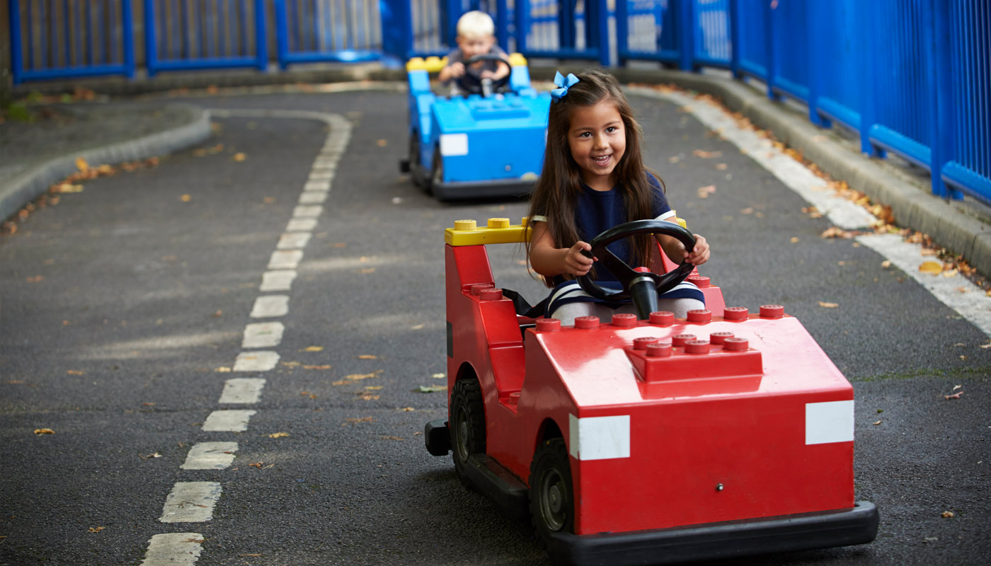 Girl and boy driving cars at L-Drivers at the LEGOLAND Windsor Resort