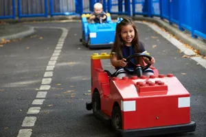 Girl and boy driving cars at L-Drivers at the LEGOLAND Windsor Resort