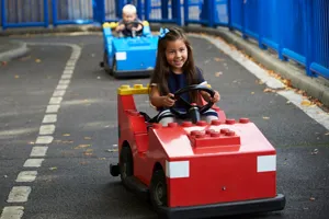 Girl and boy driving cars at L-Drivers at the LEGOLAND Windsor Resort