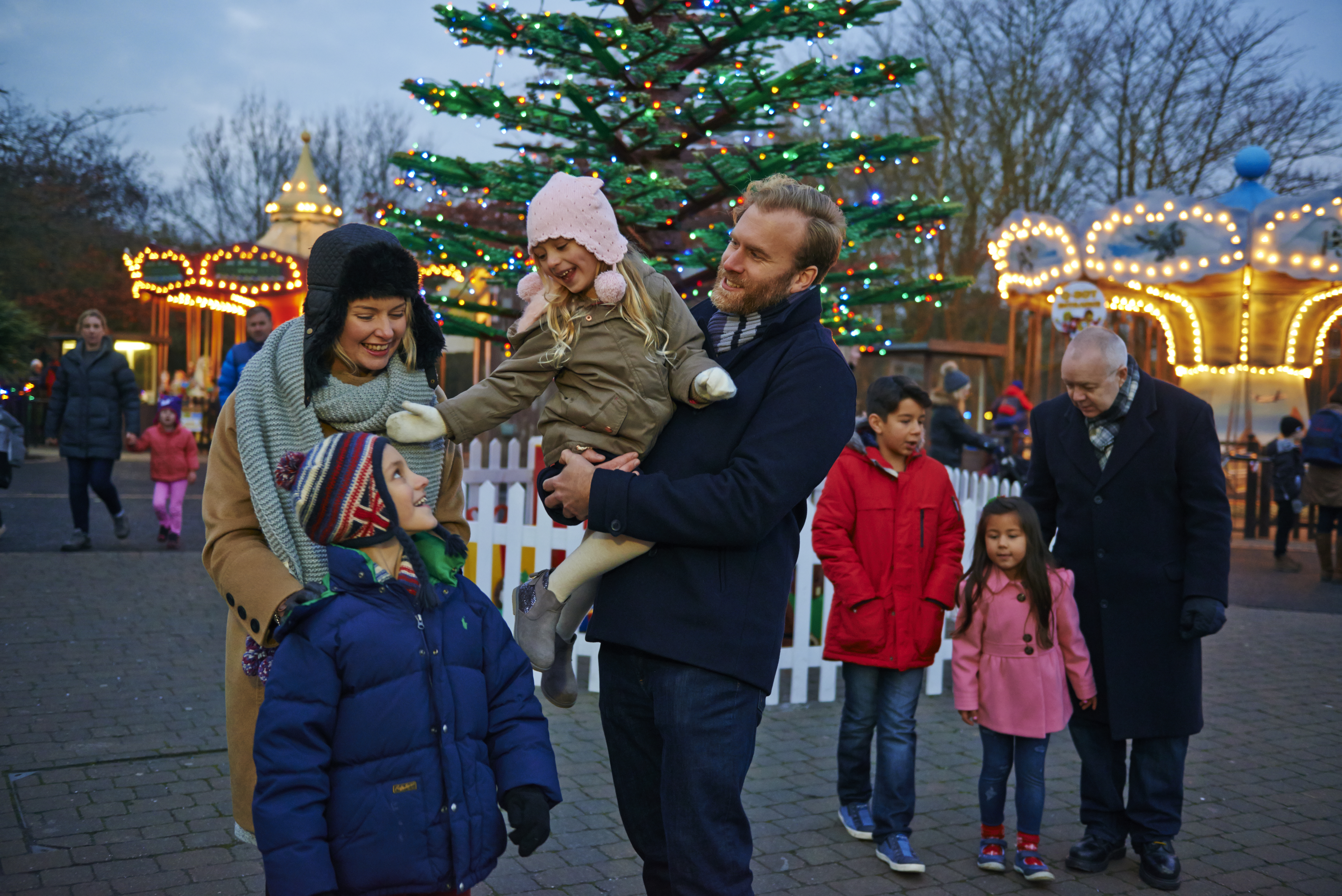 Families in front of Christmas trees at LEGOLAND at Christmas at the LEGOLAND Windsor Resort