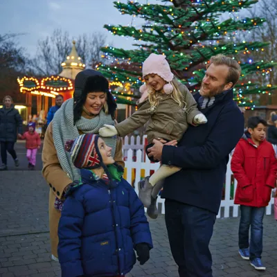 Families in front of Christmas trees at LEGOLAND at Christmas at the LEGOLAND Windsor Resort