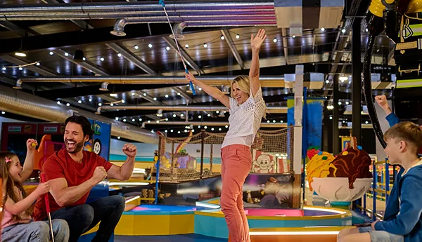 Woman celebrating with family while playing LEGO City Adventure course at LEGOLAND Adventure Golf