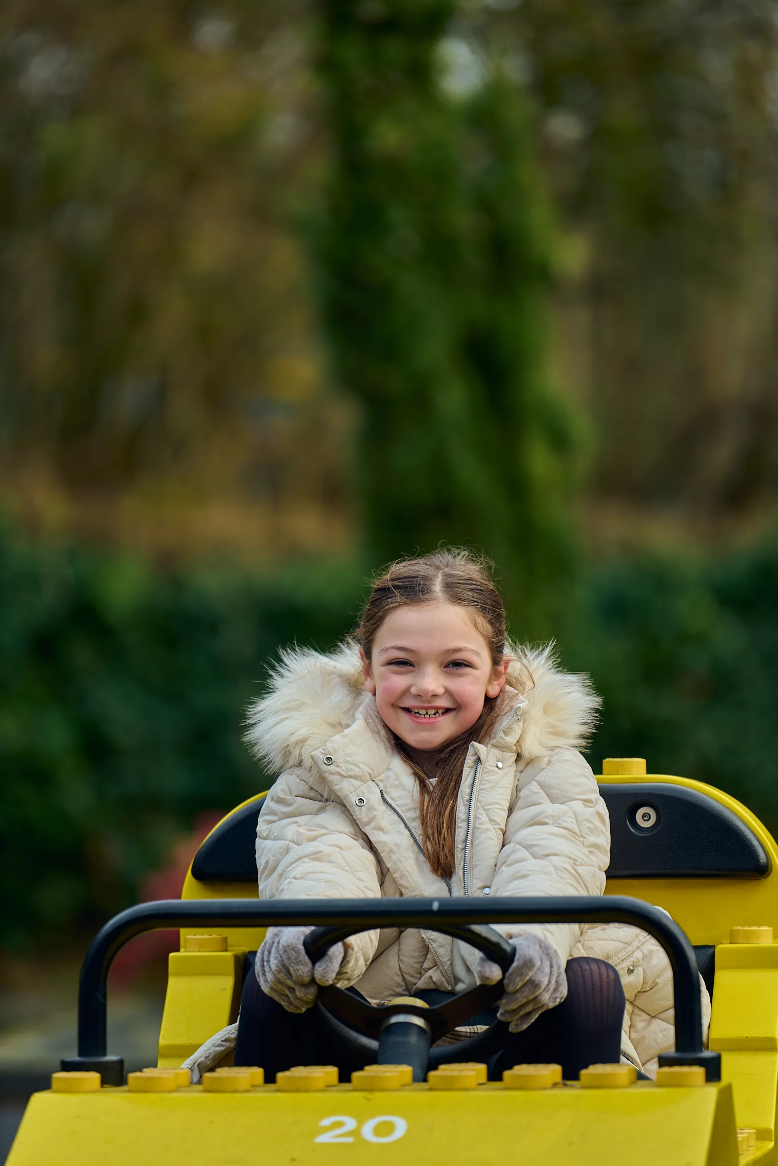 Girl in a yellow LEGO car