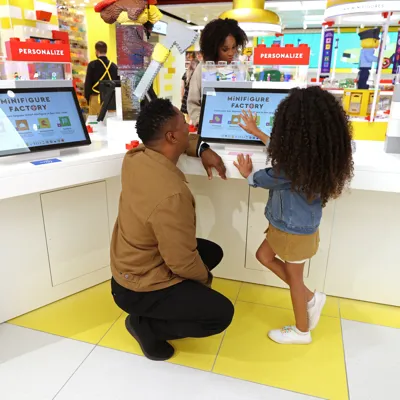 Family building Minifigures at the Minifigure Factory at The LEGO Store