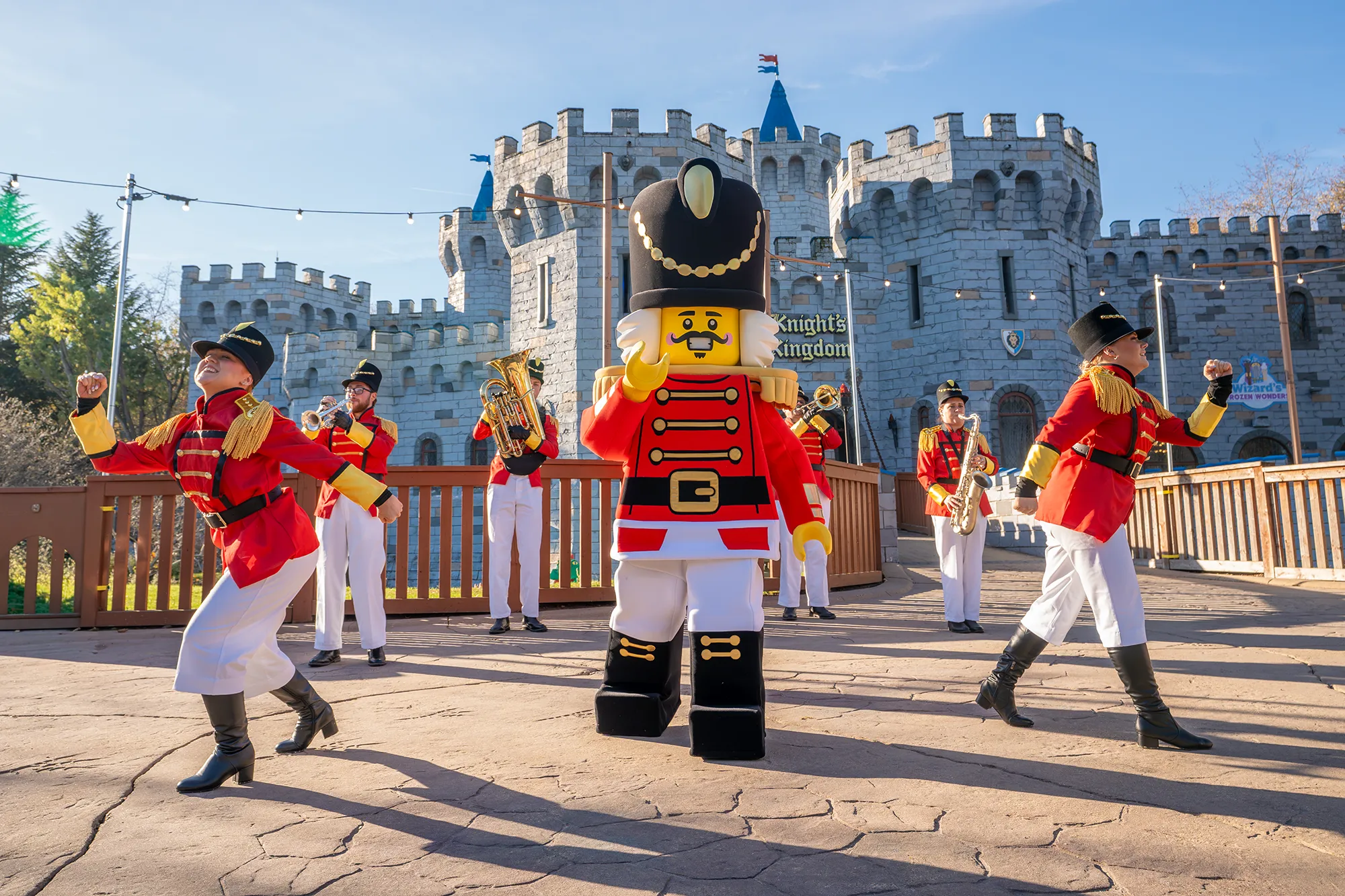 Nutcracker minifigure with his marching band and dancers outside of the Castle in Knight's Kingdom