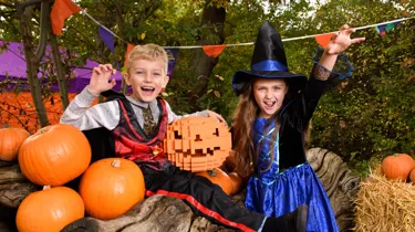 Children in Halloween costumes with LEGO pumpkin in the Enchanted Forest pumpkin patch during Brick or Treat at the LEGOLAND Windsor Resort