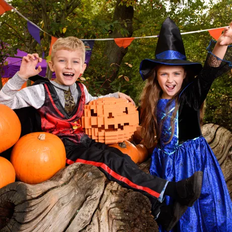 Children in Halloween costumes with LEGO pumpkin in the Enchanted Forest pumpkin patch during Brick or Treat at the LEGOLAND Windsor Resort
