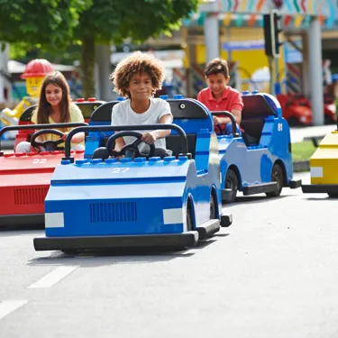 Children driving cars at LEGO® City Driving School at LEGOLAND® Windsor Resort