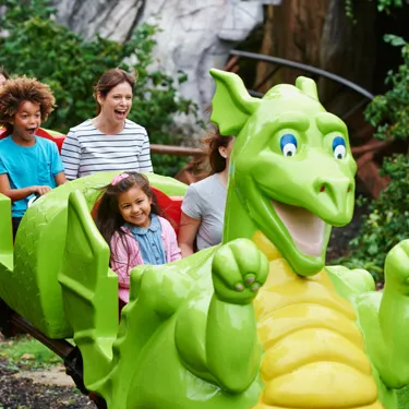 Families smiling on Dragon's Apprentice at the LEGOLAND Windsor Resort