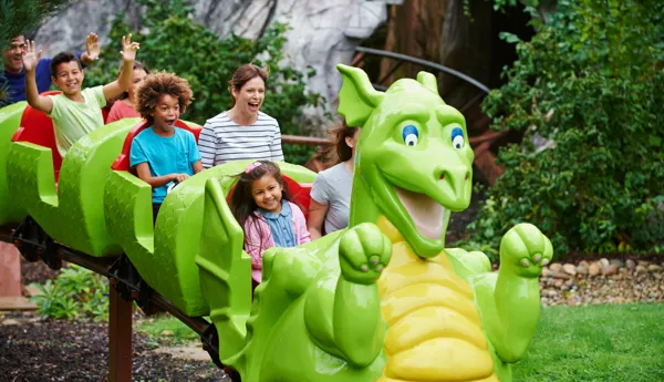 Families smiling on Dragon's Apprentice at the LEGOLAND Windsor Resort