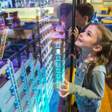 Girl looking at LEGO model in Skyline Bar