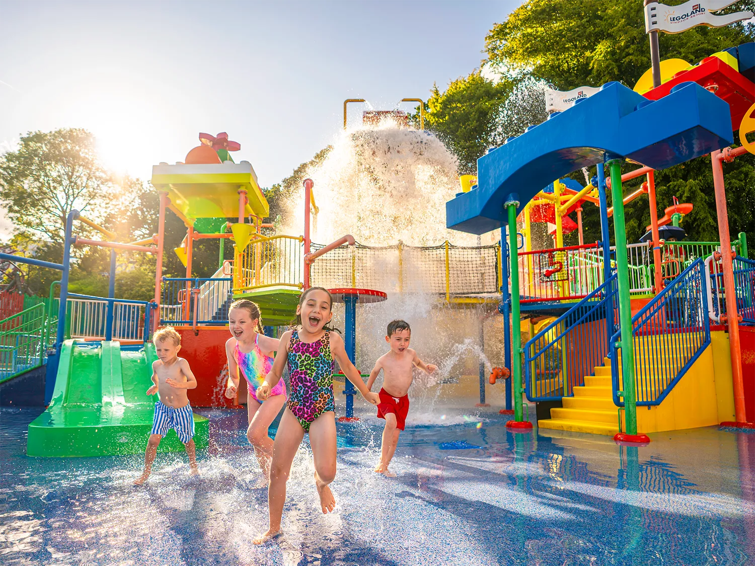 Kids laughing and playing in water at Drench Towers at LEGOLAND Windsor